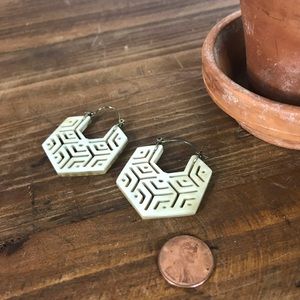 Geometric earings with cutout design.